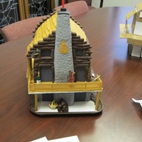 Log Cabin Chocolate Fudge Cake. Logs are made of modeling chocolate. Fondant and gumpaste accents.