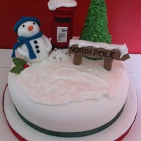 Christmas Cake Fruit cake covered in marzipan and fondant. Decorations made with 50/50. Snow effect with Royal icing.Thanks for looking.