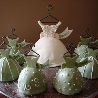 Bridal Shower Dresses covered in fondant, bodice and sashes are gum paste, hangers RI. Got this out of Wilton 2007 idea book.