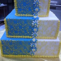 Wedding Cake Final For Class I made this cake for our final in class. It's blue and white fondant with yellow buttercream stenciling and fondant flowers.