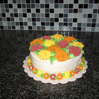 Autumn Mums Flowers made of Royal Icing, cake red velvet with buttercream icing. Cake for final class in decorating basics.