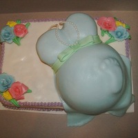 Boy Baby Shower My first baby shower cake for my sis n law...fondant foot, ball pan belly, cupcake chest, fondant bow...everyone loved it!