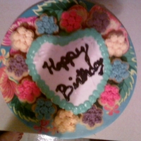 Grandma's Birthday Cake This cake was made afterwork, on super short notice! It was a little heart, and I baked little flower cupcakes and iced them in different...