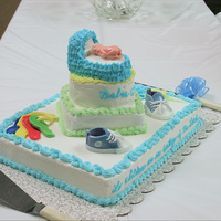 Baby Shower Cake baby made with silicone mold, keys, shoes and rocking horse all made with fondant, bassinette made from a couple of cup cakes cut to size...