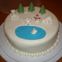 Polar Bear Cake A cake I made for Christmas... the polar bears and trees are gumpaste, snow is fondant, snowman is gumpaste with chocolate jimmies for his...