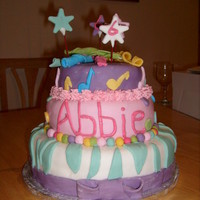 Hannah Style Themed Cake 3 tier cake, Chocolate and Vanilla Maderia, sandwiched with Vanilla Buttercream, and covered in colourful fondont