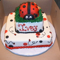 Lady Bug 10" and 6" strawberry cakes stacked with BC and MMF. Lady bug is built with cupcakes. Little Ivey's 3rd b Day