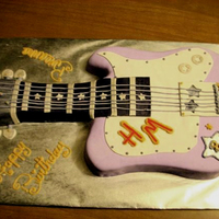"hannah Montana" 3D Guitar Cake This was a Strawberry Cake with Buttercream Frosting. It was Shaped and Covered in Fondant, and Frosting to Create Guitar Details. It also...