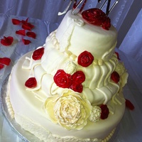 Ivory Wedding Cake Bottom is a dummy the other tiers are the actual cake. Has a peony flower which was my first and came out horrible.