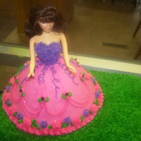 First Doll Cake yellow doll and choc grassfirst try at decorating a cake. love to do cupcakes never done a cake... was very fun...