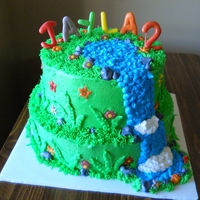 Dora The Explorer Waterfall Cake Made on February 26, 2011. Top tier is chocolate cake and bottom tier is yellow cake. Buttercream frosting and decorations with flowers,...