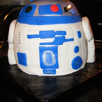 R2D2 Cake Three 8in rounds stacked and then I actually baked the top of R2D2 in a metal bowl to get the shape I needed. Then I covered it in white...