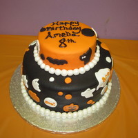 Amelia's 8Th Birthday Cake This is a picture of my first fondant cake. My daughter wanted me to make her birthday cake and wanted a Halloween theme. She helped me in...