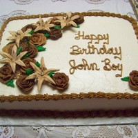 First 1/2 Sheet Cake Just finished the Wilton Flowers & Cake Design class the week before making this. Buttercream frosting, royal icing flowers.