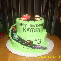 Cars Spiral Cake Disneys Cras cake for little boy`s bday. Chocolate cakes covered in buttercream. MMF mcqueen and mater toppers, other cars are cookies that...
