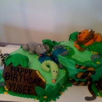 Jungle Cake My first cake - fondant animals and accents on a butter cream cake with piping gel for water