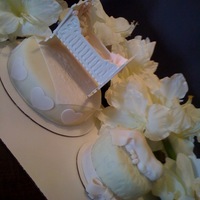 Baby Shower Cakes white chocolate cradle with fondant accents and a sleeping baby. Pale pink and ivory cake.
