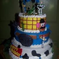 Toy Story All white cake, covered in MMF. Mr. Potato Head is MMF other characters are toys. This cake was taken from other photo ideas. I do not know...