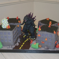 Godzilla Cake My friend's son wanted a Godzilla Cake and I was not about to scuplt Godzilla out of cake, so he got a Godzilla toy with burning...
