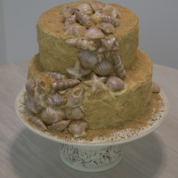 Beach Cake For my grandma's 80th birthday. Butter pecan cake with coconut pecan filling and grahmn cracker sand. Shells are white chocolate and...