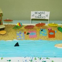 Ocean Theme 16x16 pans, half choc, half vanilla. bc icing and mmf accents. hut is grahm crackers covered in candy melts