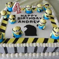 Dispicable Me/ Minions Cake This cake was so fun to make the little Minions took a long time but I was happy with them in the end. They look so cute on the cake!
