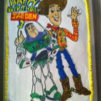 Toy Story Cake This was one of my first cakes I painted Buzz and Woody on rice paper with piping gel on whipping cream.