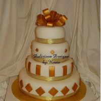 Gold Graduation This was for a formal graduation party. Cake was covered in white fondant with the accents in gold luster dust...that stuff is great! Cake...