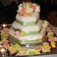 Anniversary This is a hexagon covered in whote fondant with fresh roses. The green was the same color of the girls dresses the day of the wedding (5...