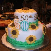 Sunflowers This was a sunflower cake I made for my Aunt's 50th birthday. Chocolate cake with Buttercream, covered and decorated with fondant.