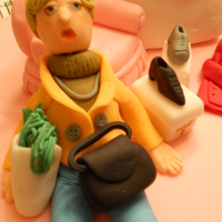 Shopaholic Cake Two tiered butter cake covered in pink fondant with an exhausted fondant shopper, surrounded by bags and goodies from a long day at the...