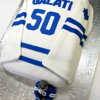 Hockey Jersey Cake This hockey jersey cake was a hit for a 50th birthday for a huge sports fan. Two layered cake covered in fondant. A small figurine to go...