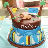 King Of The Jungle French vanilla cake with chocolate buttercream covered in marshmallow fondant. Fondant/gumpaste figures. 8 & 10 in. cakes.