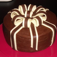 Chocolate Ribbons Spiced chocolate torte, rum chocolate buttercream, chocolate expresso honey glaze, wrapped in semi-sweet/white chocolate ribbons.