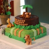 Jungle Twin Baby Shower Bottom tier is a four layer french vanilla torte with raspberry filling and a vanilla buttercream. Top tier is a dark chocolate turtle cake...