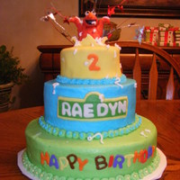 Raedyn's Birthday Fondant Elmo Bursting from buttercream icing cake.