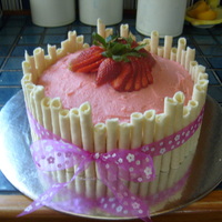 Vanilla Bean And Strawberry Cake Vanilla Bean cake filled with diced strawberries and with strawberry ganache. Topped with strawberry ganache, and surrounded in wafers...