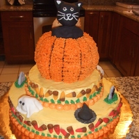 Kitty In A Pumpkin Chocolate cake with butter cream frosting. A cat formed from cereal treats and covered in fondant sticks out of a cake pumpkin. The cat is...