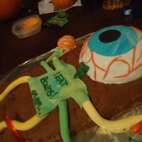 Alien Eyeball This cake was 3 cakes total; all white cake dyed halloween colors. The brown is chocolate butter cream while the "eyeball" is...