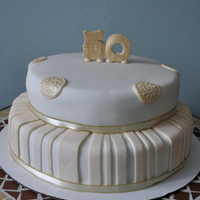 50Th Anniversary Vanilla cake covered in buttercream and then covered in fondant. I didn't achieve the gold colour I had hoped for in the topper/...