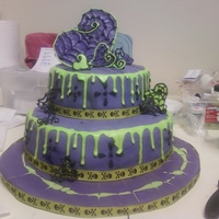 First Tiered Cake My first tiered cake, only my second time covering cake in fondant. Topper and pieces are color flow. Bottom tier is chocolate caramel cake...