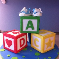 Building Blocks And Baby Shoes This is an amalgamation of cakes I've seen...mostly based on a design by Elisa Strauss...but many thanks to StellaStarChild for her...