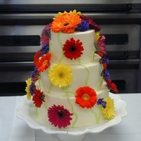 Meike's Wedding Cake She loves Gerbera Daisies. In order to avoid an issues with inedible flowers, I wash them well and dip the bottoms in melted paraffin wax...