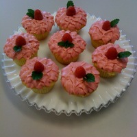Raspberry Shortcake Cupcakes Yellow cupcakes with raspberry cream cheese icing piped with a leaf tip.