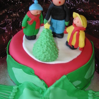 Choir Singers Around Christmas Tree Mud cake, with buttercream and MMF, gumpaste choir, tree & scarf.