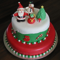 Christmas Cake 12" Mud cake with chocolate ganache & MMF, with a 9" white choc mud cake stacked on top. Christmas colours and themed...