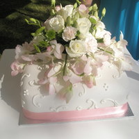 Ochids And Scrolls Single layer Wedding cake. The fresh flower arrangment was also done by me.