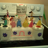 My Second Castle Bottom and top tiers are cakes, towers are plastic containers, figurines are plastic. All covered in fondant and accents are buttercream.