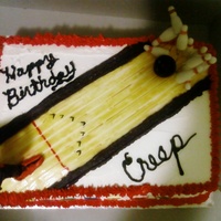 Birthday Bowling Cake Bowler made of modeling chocolate, shirt, pins and bowling ball made of fondant.