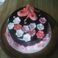 Ballet fondant ballet shoes and flowers. i donated this to the dance clubs bake sale. i used cotton candy around the bottom of cake in an attempt...